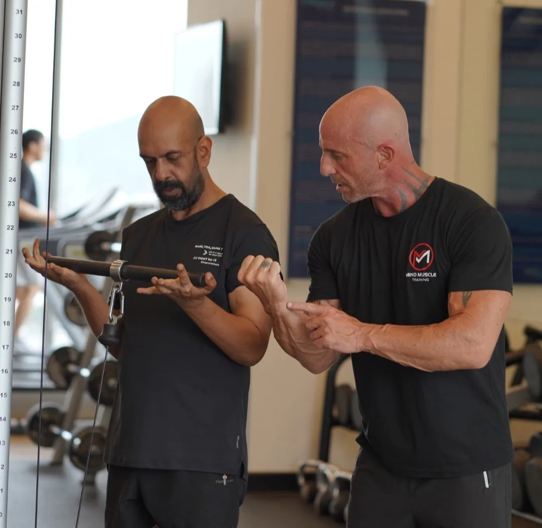 Ian coaching a client through a cable exercise at the Da Nang gym