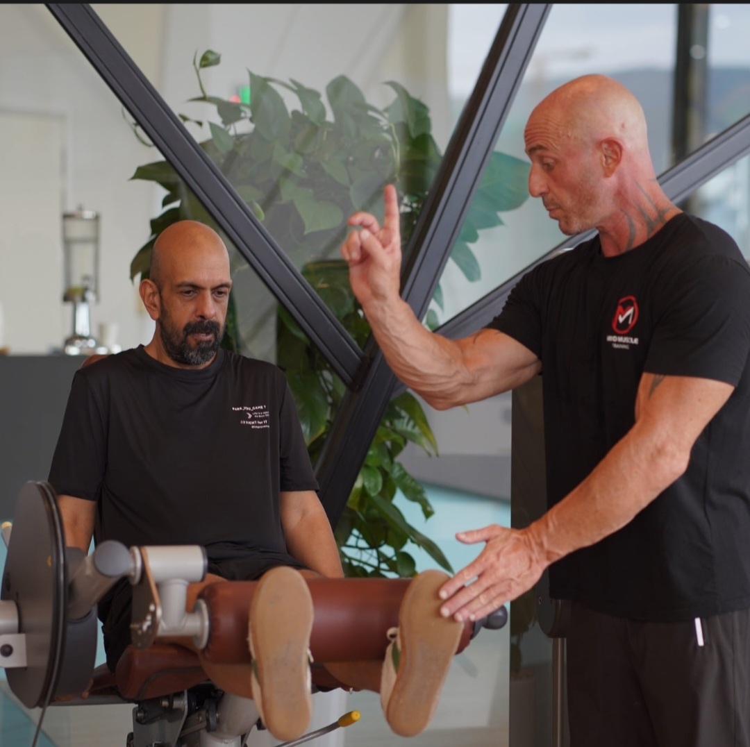 Ian giving hands-on form coaching to a client at the Da Nang gym